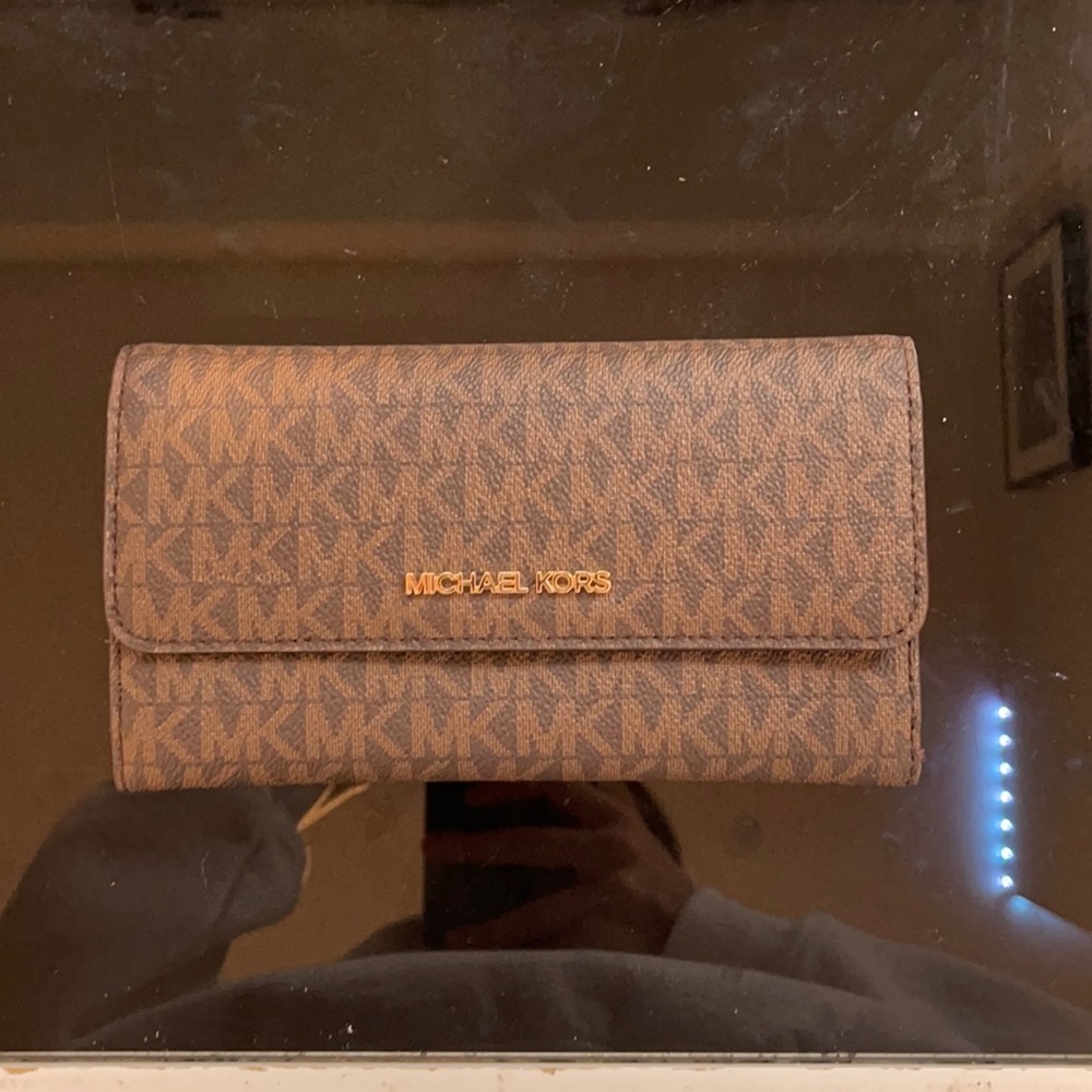 Large logo and orange leather trifold wallet